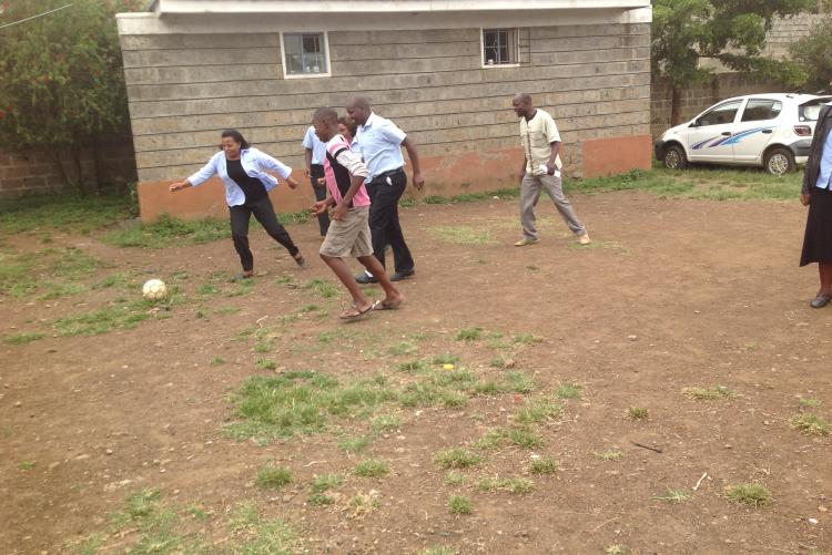 Ms Irene, Mr James and Mr. Henry shows the kids the art of playing football in Life Children Home