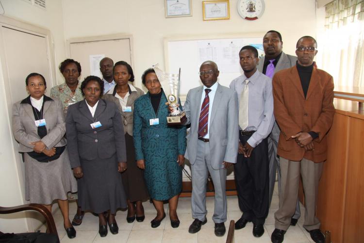 The Internal Audit staff posing with the trophy