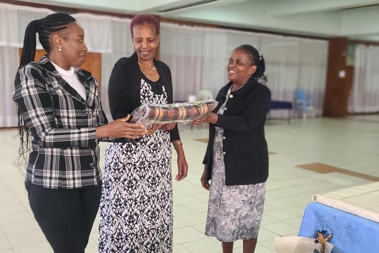 Deputy Director Ms. Hannah with Ann giving Emma a Gift 2