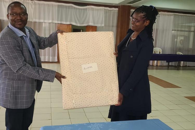 Director Mr. Gitau givving Ann a Gift 1