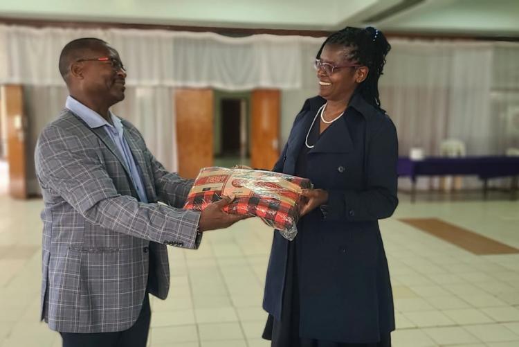 Director Mr. Gitau givving Ann a Gift