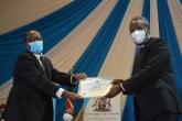 The CIA, Mr Kenneth Gitau receiving the certificate of best performance in Central Administration College