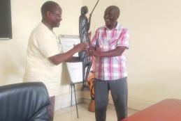 Director presenting a gift to Mr. Ndirangu