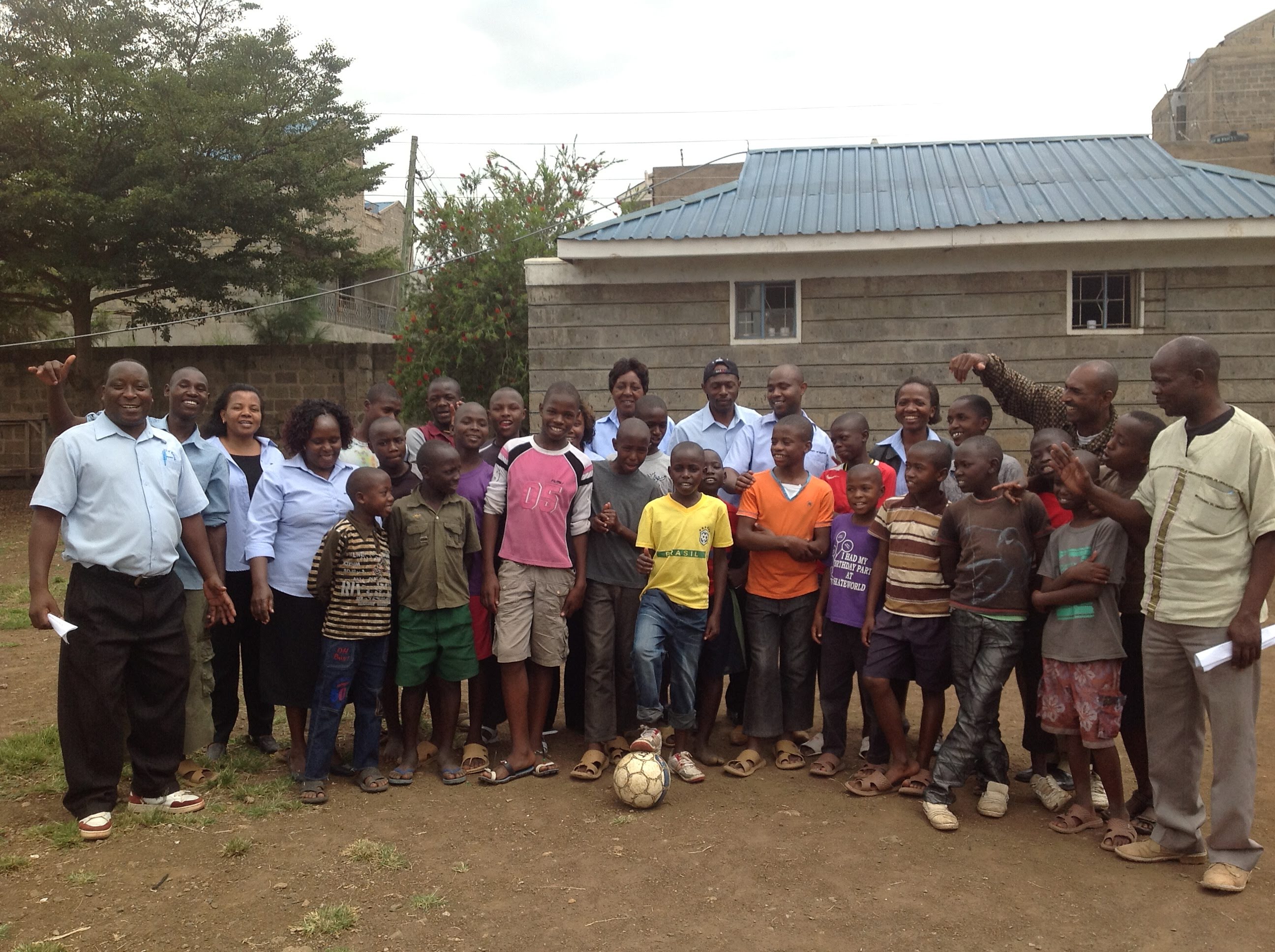 Posing with the kids from the children's home after a football match 