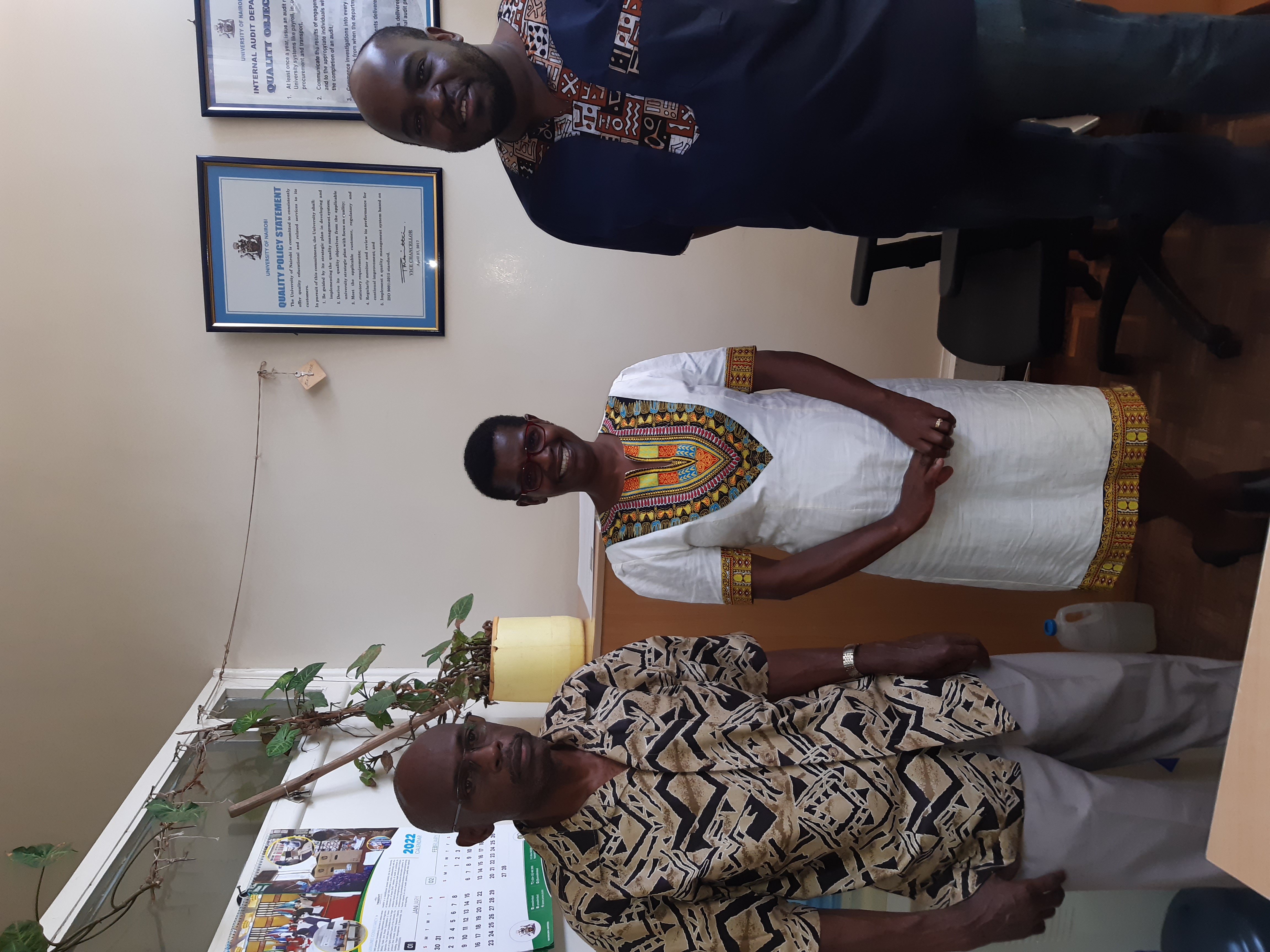 Ms Anna, Mr Manono and Mr Langi posing for a photo in African attire