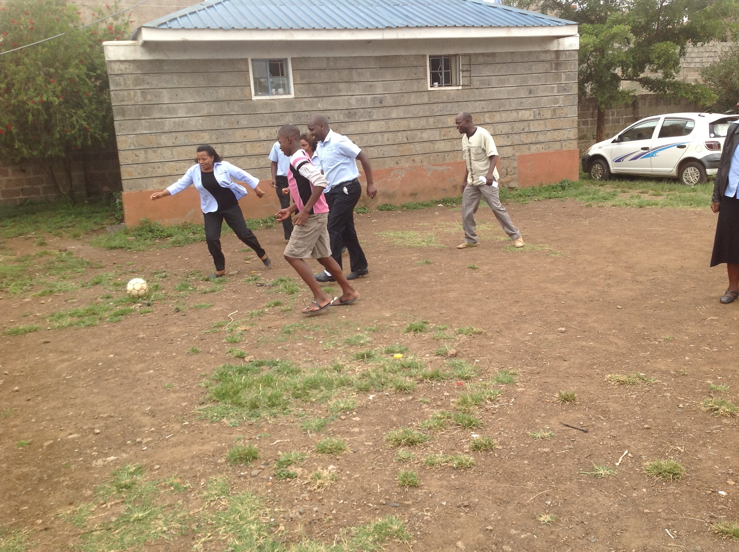 Ms. Irene playing football with the kids from Children home. 