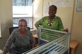 Ms Emmah and Ms Tecla checking on a document