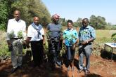 From Left Mr Kapiyo, Mr Warutumo, Ms Nduta, Ms Ann and Mr Douglas holding their trees ready for planting